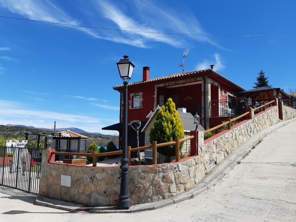 a street light in front of a building at Casa Rural La Casita Roja in Burgohondo