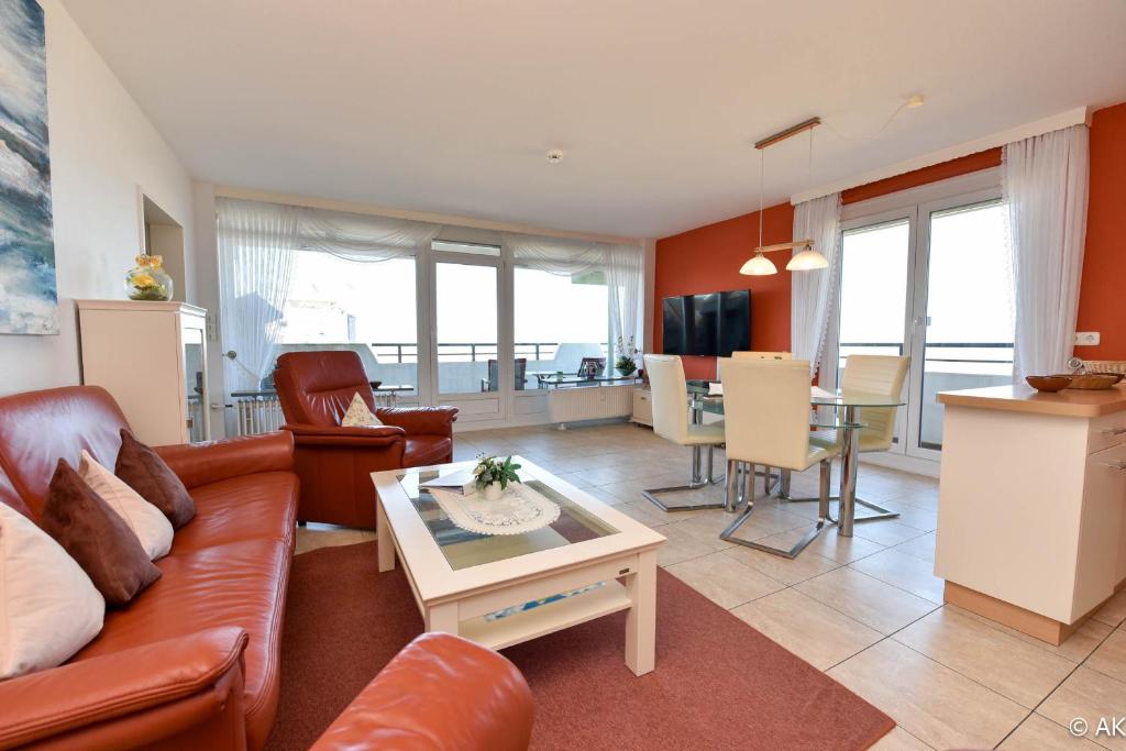 a living room with a couch and a table at Haus "Panorama" Appartement PAN063 in Duhnen