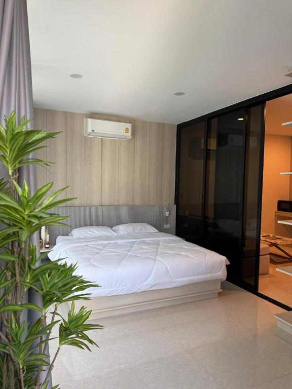 a bedroom with a large white bed in it at Patong Beach Apartment Lux in Patong Beach
