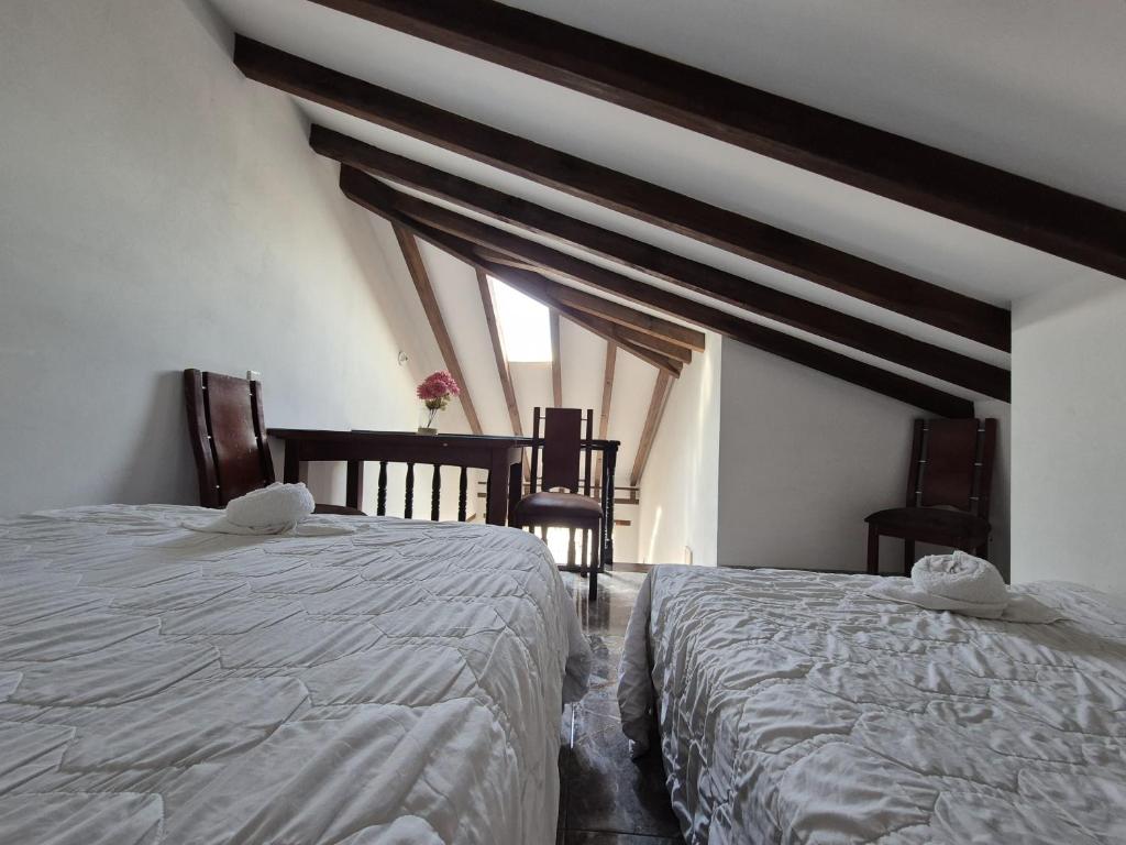 a bedroom with two beds and two windows at Apto Beija Flor - Gran Capacidad in Villa de Leyva