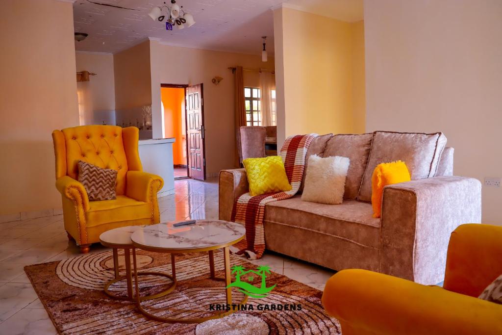 a living room with a couch and two chairs and a table at Kristina Gardens in Voi