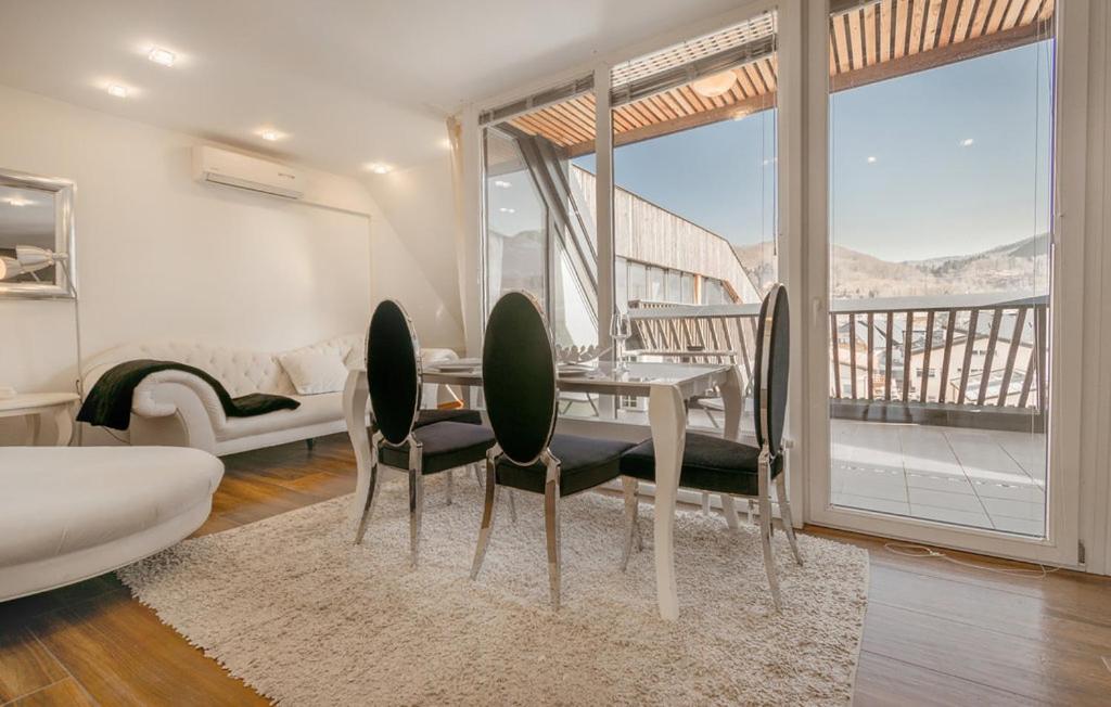 a dining room with a table and chairs and a balcony at Apartments Eurolux - Bohinjska Bistrica in Bohinj