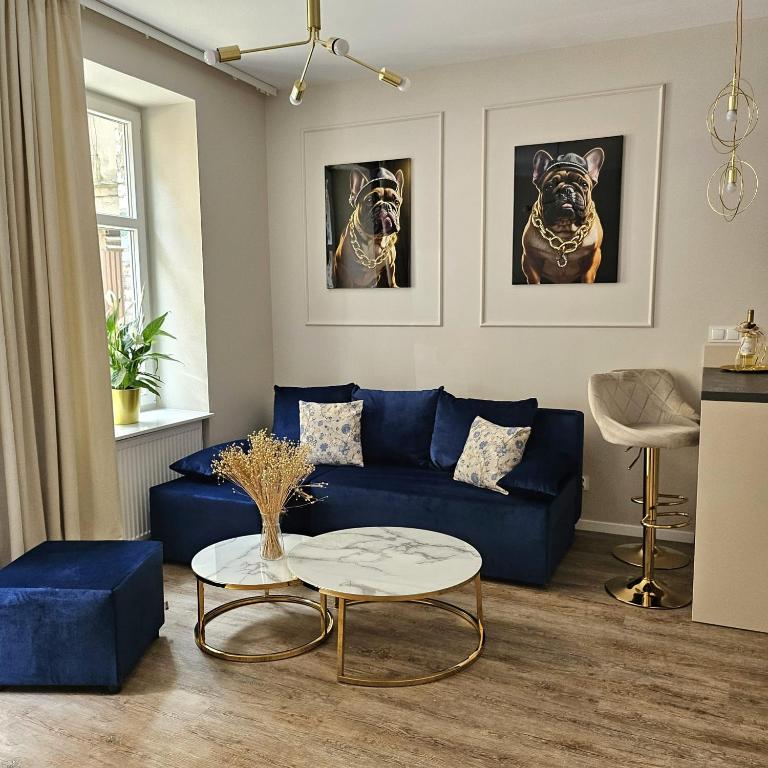 a living room with a blue couch and a table at Golden Key 35m2 aprtament blisko Dworzec, Spodek, MCK, Self check-in, Parking in Katowice