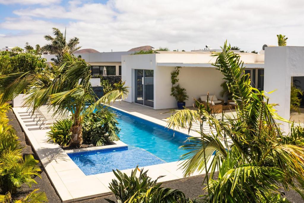 an image of a villa with a swimming pool at Golf Palms in Costa Teguise
