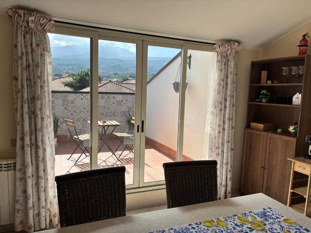 a room with a sliding glass door with a view of a patio at La mia dolce casa in Mascali