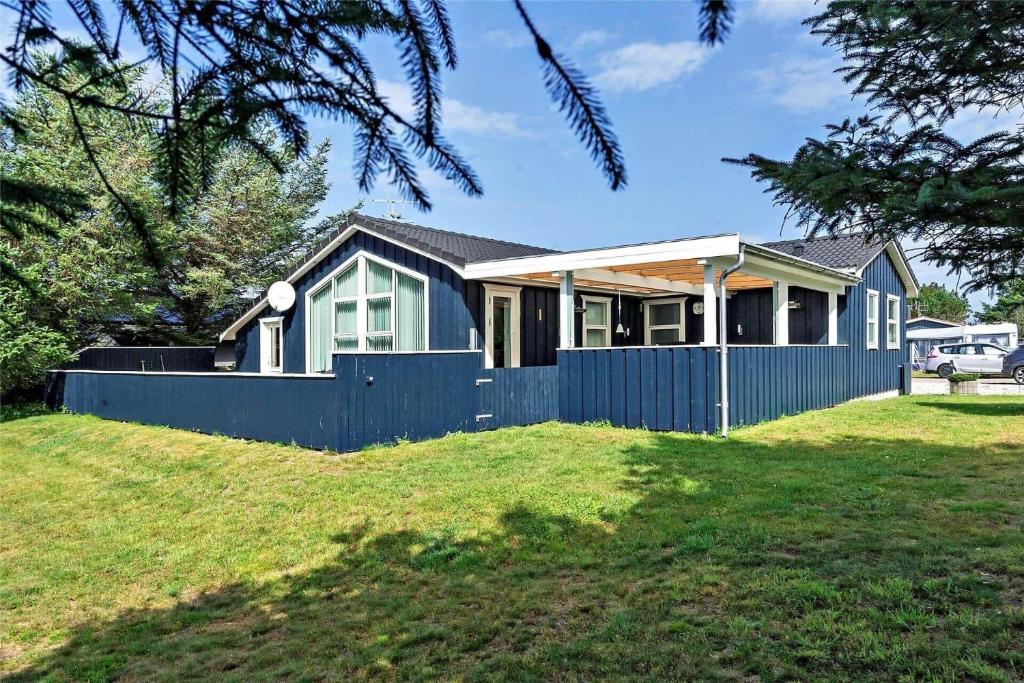 a house with a blue fence in a yard at 618-Thisted-Fiskervej-82 in Thisted