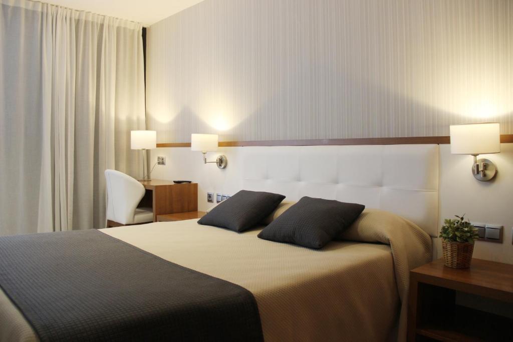 Cama o camas de una habitación en Hotel Teruel