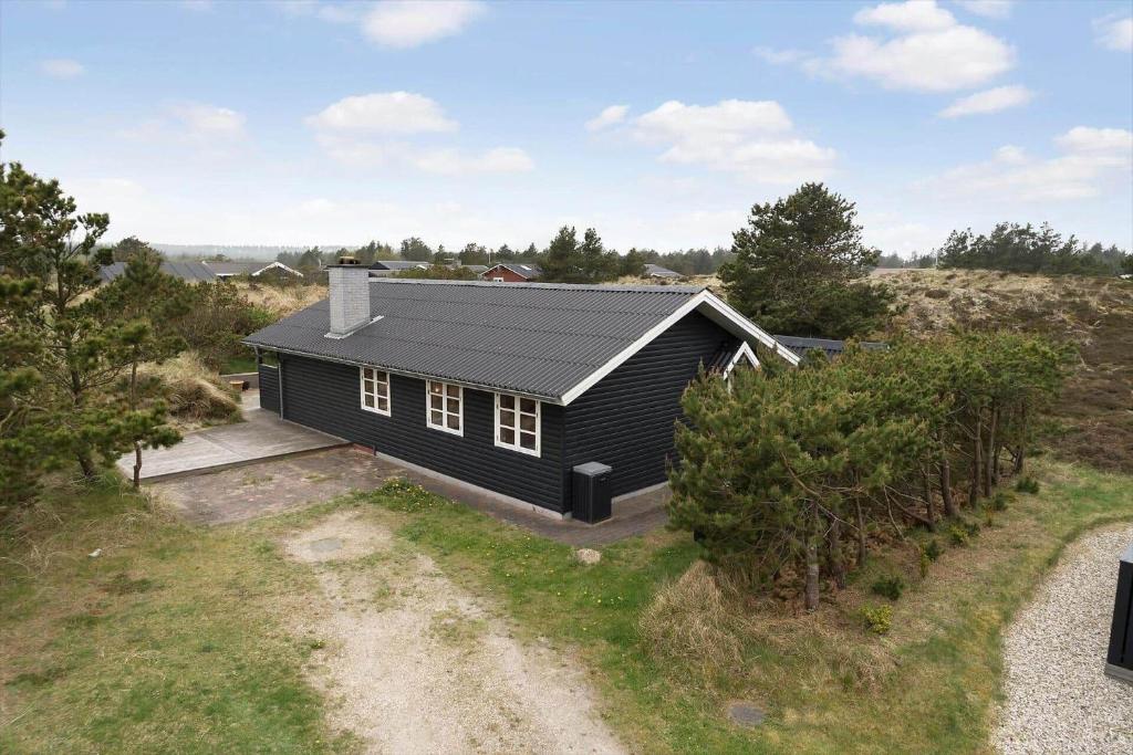an aerial view of a black house on a hill at 930-Thisted-Liusborg-Sti-28 in Torsted
