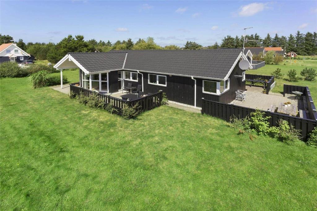 a small house with a large yard with a grass field at 512-Thisted-Sotungevej-4 in Thisted