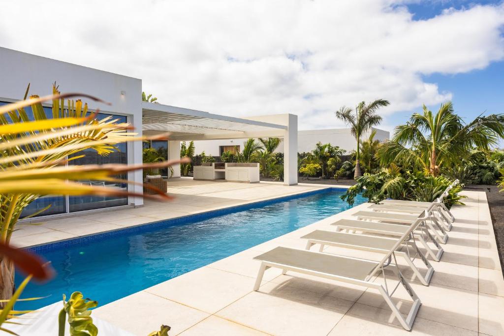 an image of a swimming pool at a villa at Golf Palms in Costa Teguise