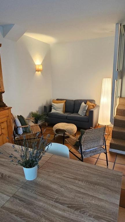 a living room with a couch and a table at Les Platanes in Yvoire