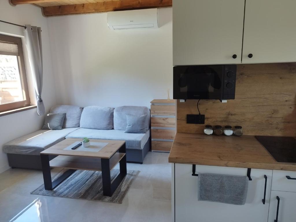 a living room with a couch and a table at Dychnij Se in Myczków