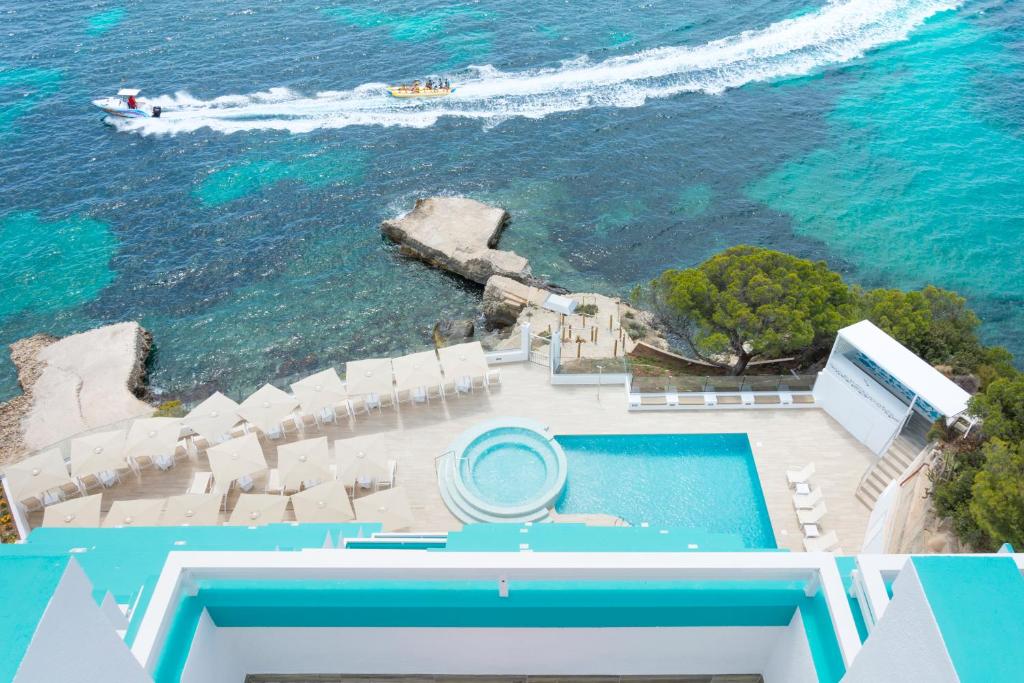 an aerial view of a swimming pool and the ocean at HSM Sandalo Beach in Magaluf