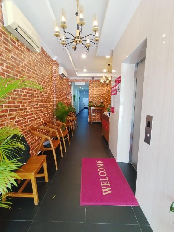 a restaurant with a pink welcome mat on the floor at J Hotel Masjid India KL in Kuala Lumpur