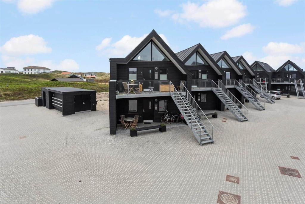 a black house with a row of stairs in front of it at 785-Thisted-Havstokken-32-A in Thisted