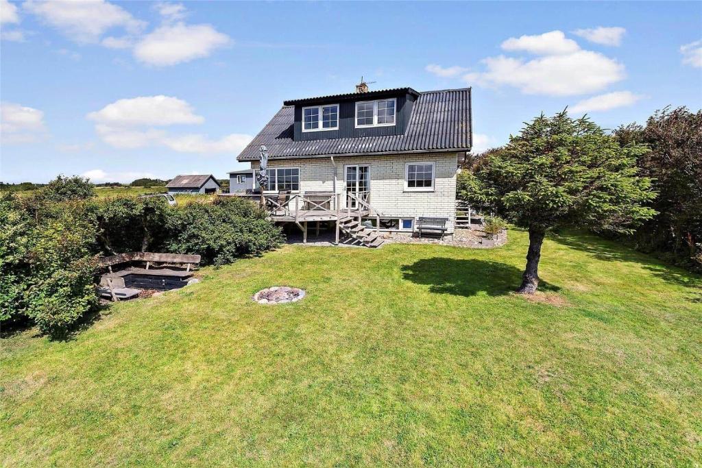 a large house on top of a grassy hill at 204-Vestervig-Lodbjergvej-4 in Vestervig
