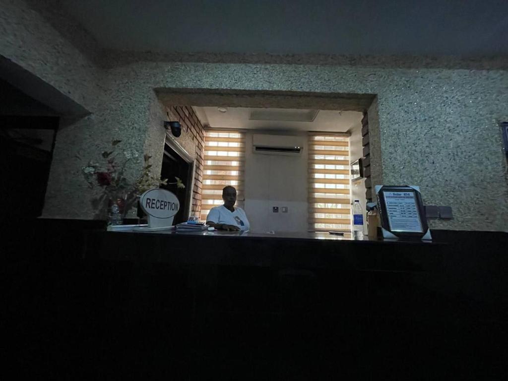 a man standing at the counter of a restaurant at Suite 104 Hotel in Mama