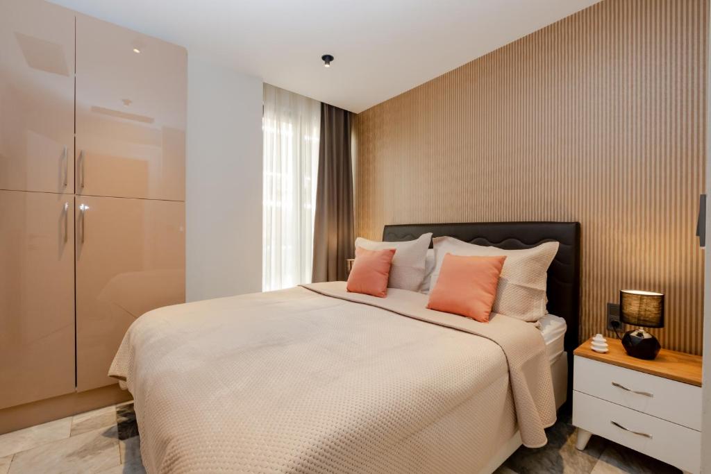 a bedroom with a large bed with orange pillows at Istanbul Apartments in Istanbul