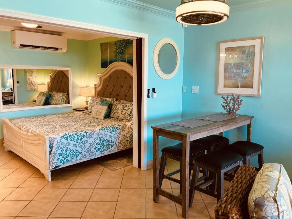 a bedroom with a bed and a table in a room at C206 - Sapphire Beach - Sapphire Jewel VI in East End