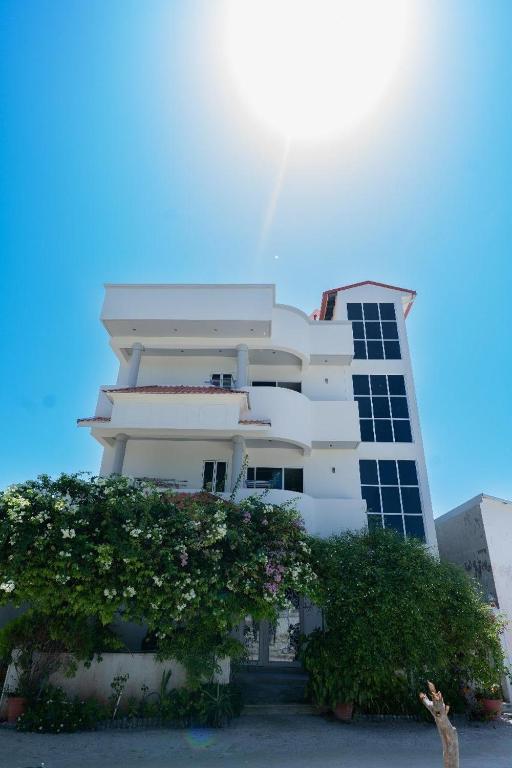 a white building with a lot of windows at Fen Villa in Dharavandhoo