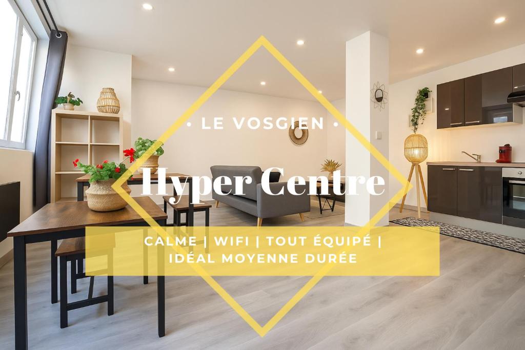 a living room with a table and a kitchen at Le Vosgien - Hyper center - Calme - Wifi - Spacieux in Épinal