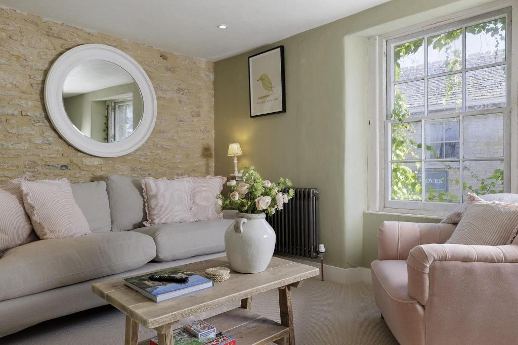 a living room with a couch and a table at Flat 2 Martins House in Stow on the Wold