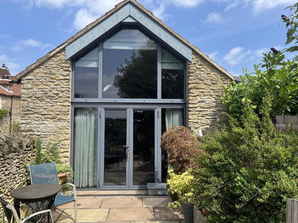 an extension to a cottage with glass doors at The Nail Shed in Scarborough