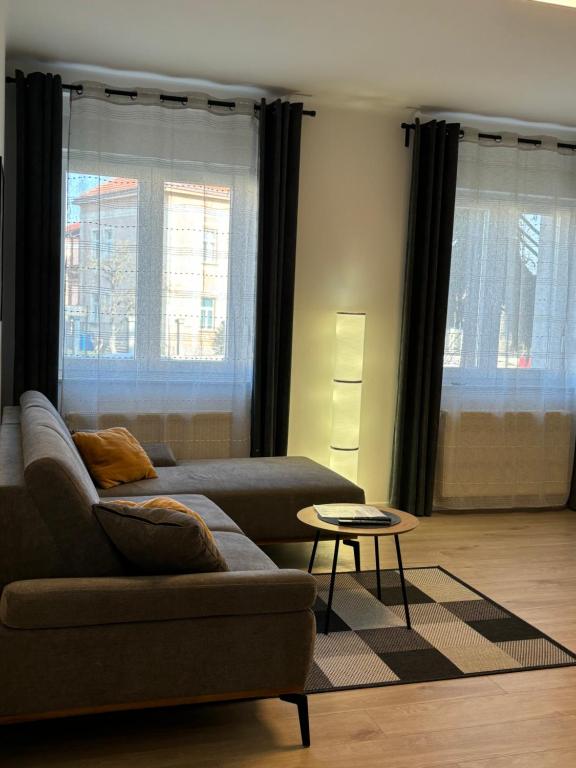 a living room with a couch and a table at Sonas in the city center in Karlovac