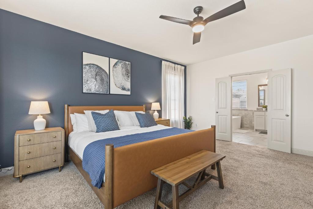 a bedroom with a bed and a ceiling fan at Luxe Retreat with EV Charger & Putting Green in Frisco