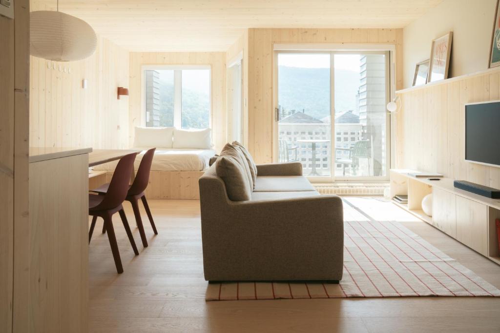 a living room with a couch and a table at Volume Nord in Stoneham