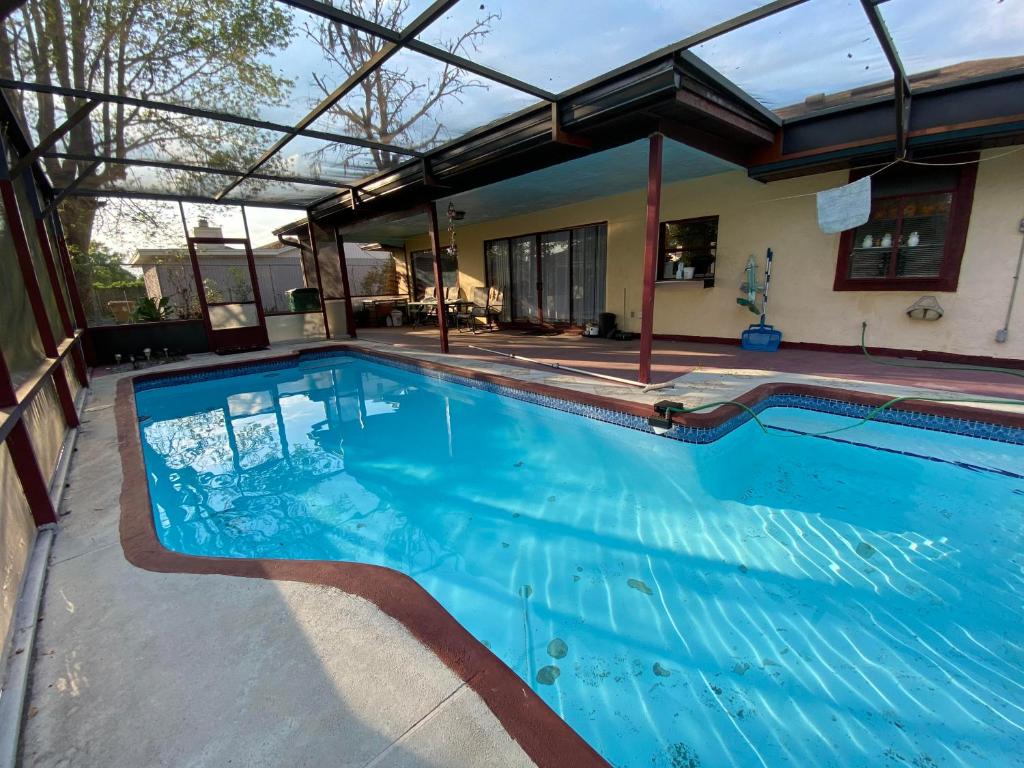a large swimming pool in a house at Peaceful stay at Grandmas house in Kissimmee