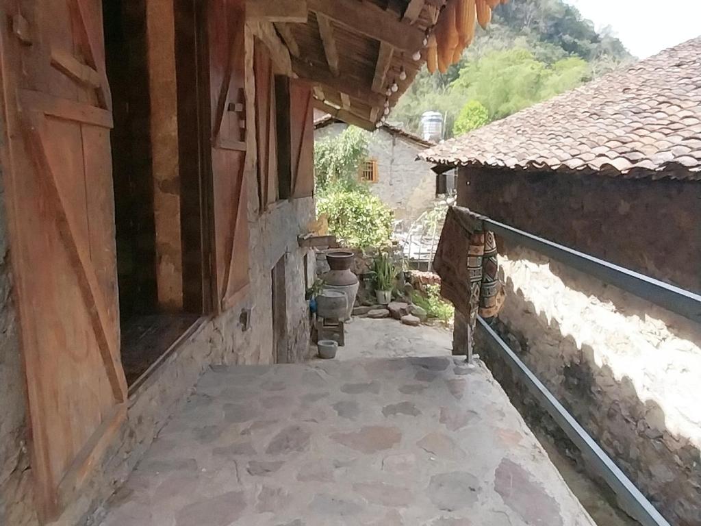 an outside view of a building with a person standing on a porch at Triệu hoan homestay nhà sàn cổ in Dam Thuy