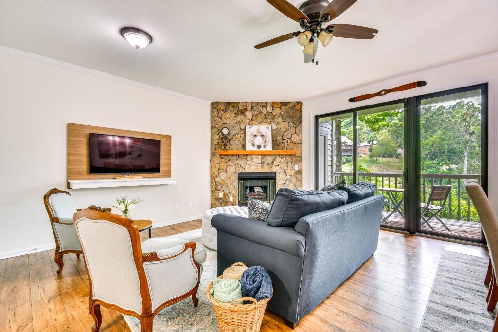 a living room with a couch and a fireplace at Mtn Cabin with Balcony and View in Burnsville! in Burnsville