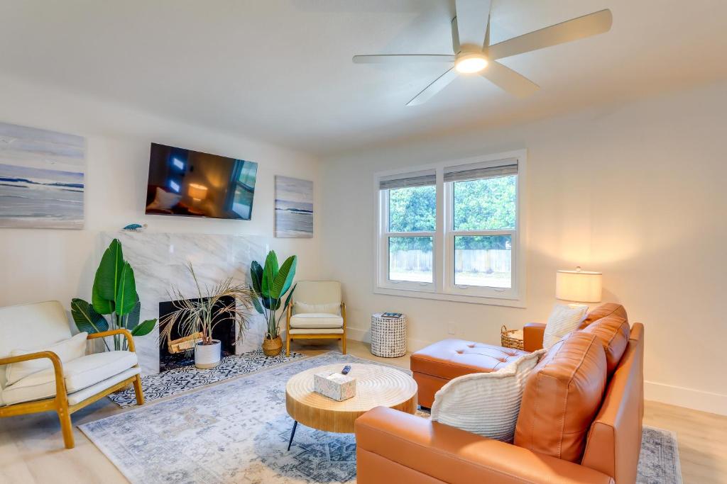 a living room with a couch and a ceiling fan at Private Hot Tub and Fenced Yard Sleek Gulfport Home in St Petersburg