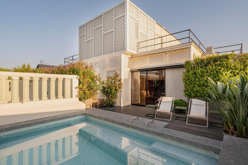 a house with a swimming pool in front of it at Vincci Mae in Barcelona