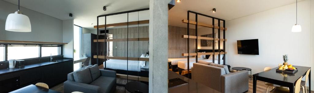 a living room with a couch and a bedroom at Nucleo Mayor Apart in Santiago