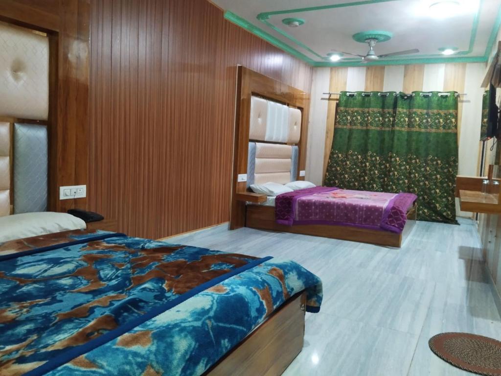 a bedroom with two beds and a mirror at Sehran palace in Srinagar