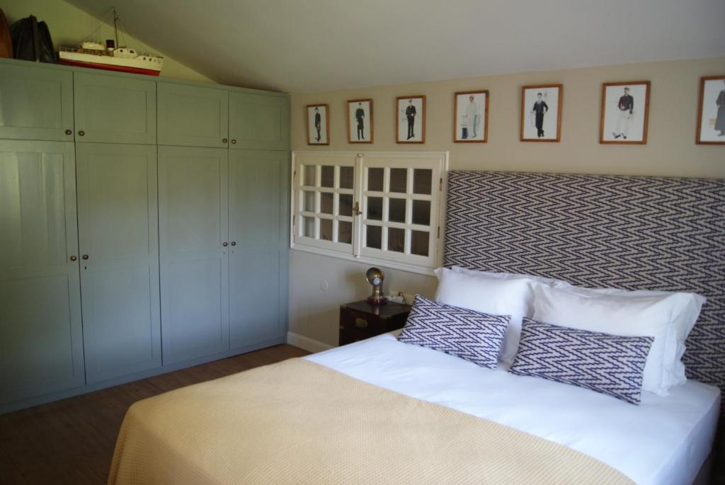 a bedroom with a bed and white cabinets at Villa Trypiti in Limenaria