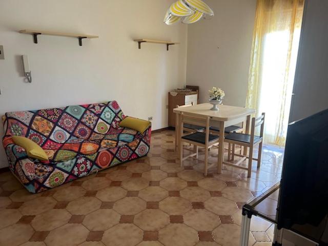 a living room with a couch and a table at Holiday residence Sole San Marco in Calatabiano
