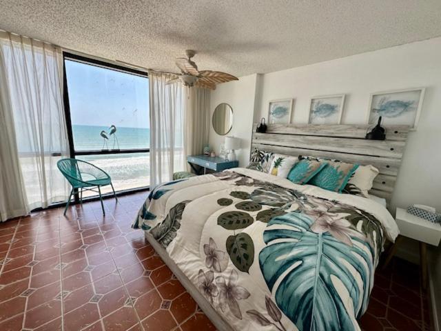 a bedroom with a bed with a view of the ocean at Daytona oceanfront two-bedroom suite in Daytona Beach
