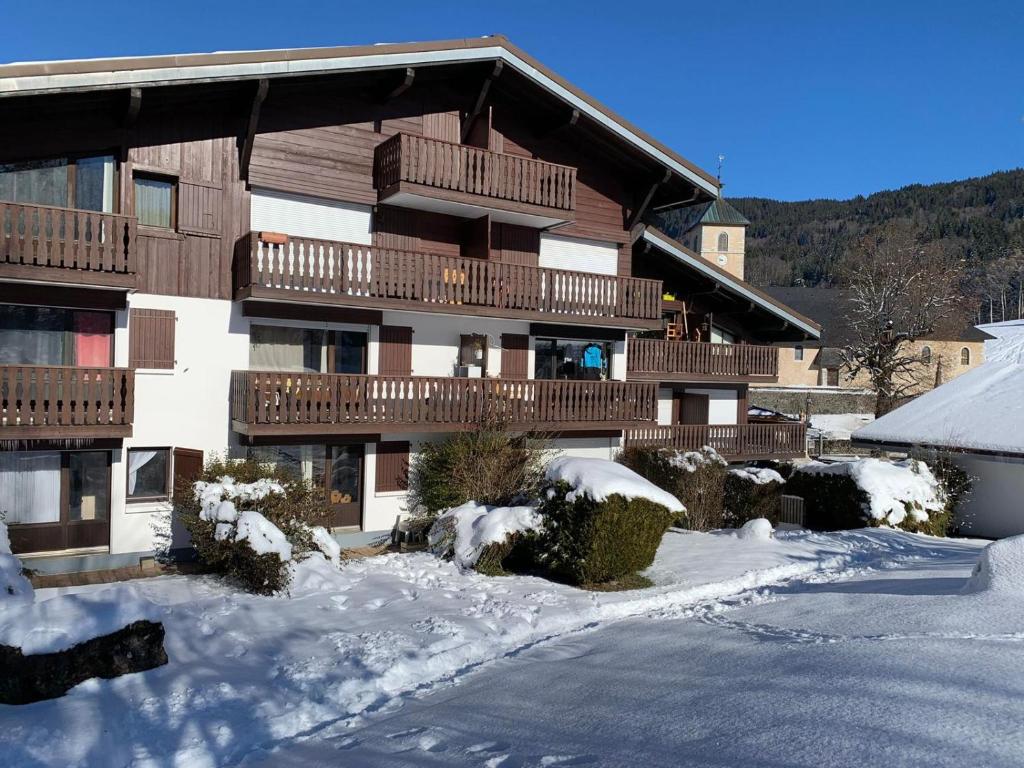 a large building with snow in front of it at Appt de montagne Araches in Arâches-la-Frasse