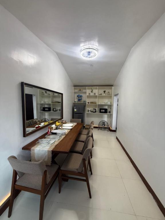 a dining room with a long table and chairs at Affordable Yet Luxurious Family House in Uptown CdeO in Cagayan de Oro