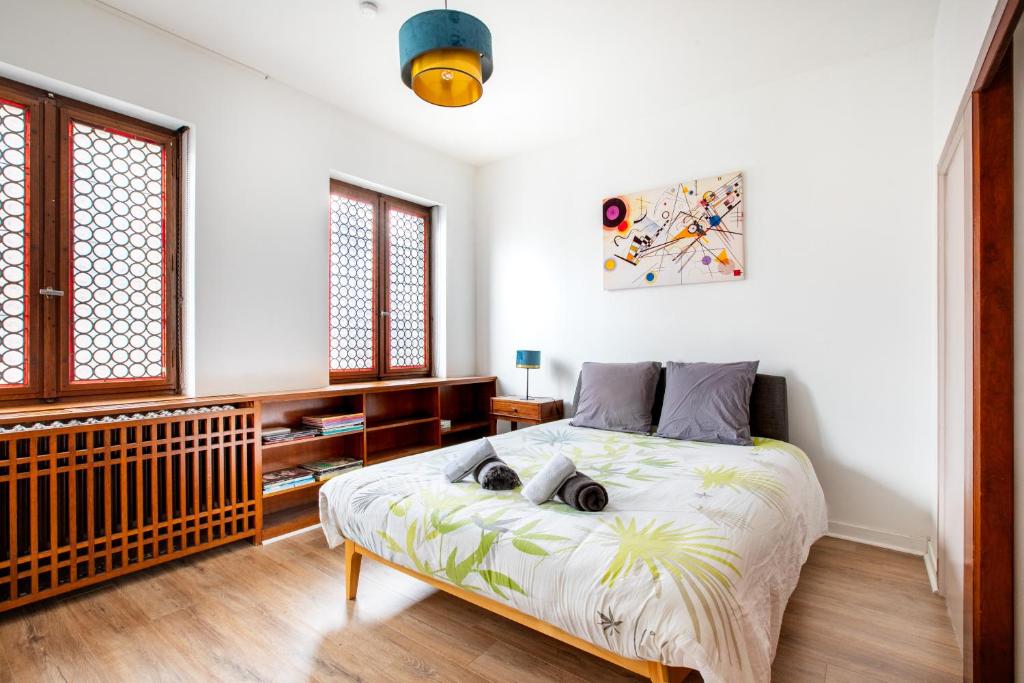 a bedroom with a bed with two dogs laying on it at Two room apartment - centre historique in Mulhouse