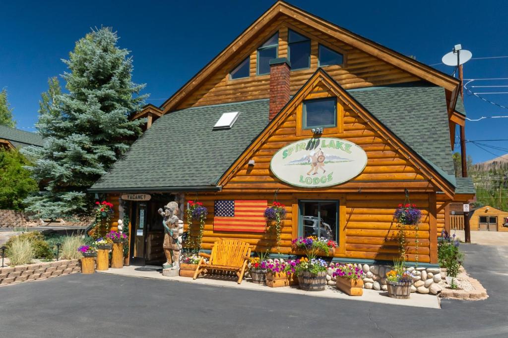 a log cabin with an american flag on it at Spirit Lake Lodge in Grand Lake
