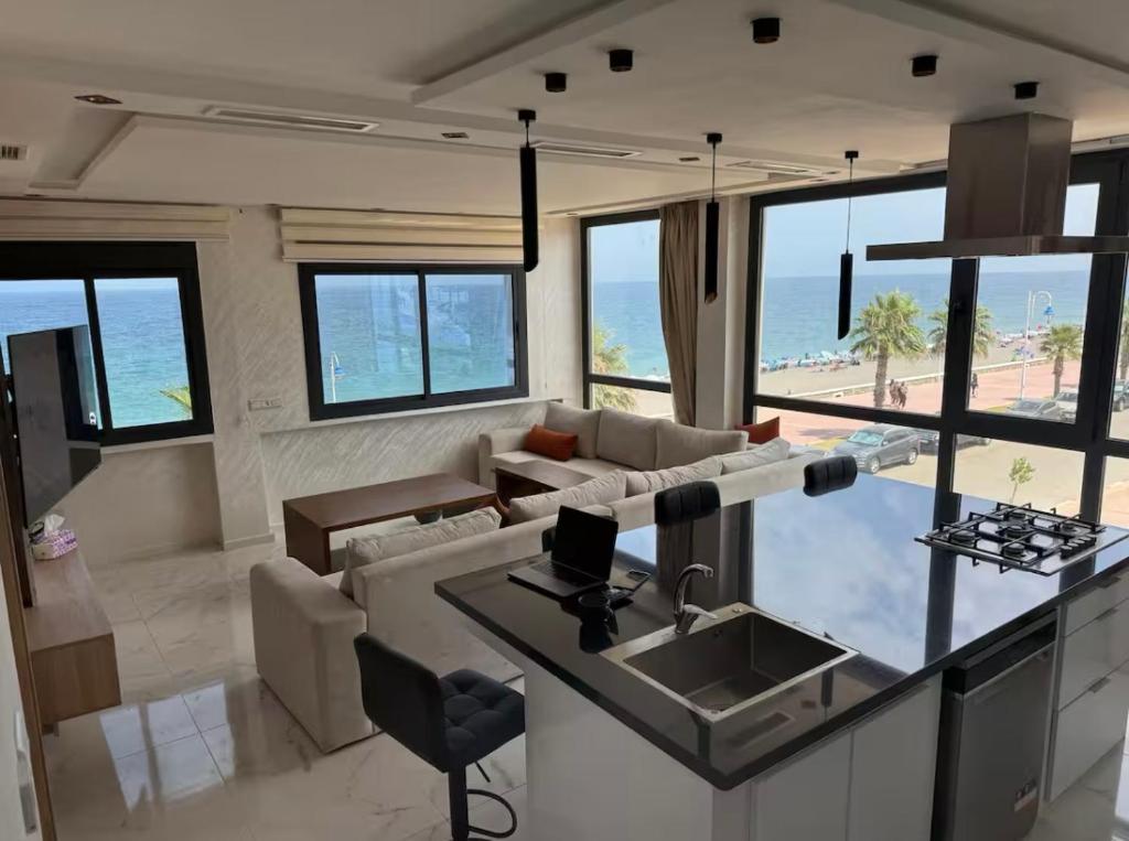 a living room with a couch and a table at New 2025, Front beach flat, Newly renovated in Oued Laou