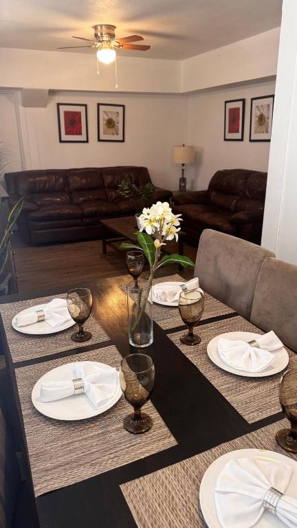 a living room with a table with plates and flowers at 3 Bedrooms Florida Sunshine in Pompano Beach