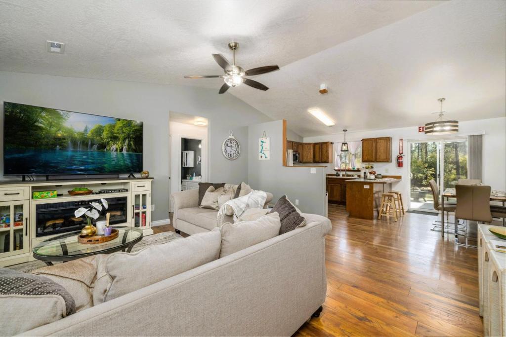 a living room with a couch and a tv at Cozy 3-Bedroom Retreat with Fenced Yard, Games & BBQ- Pet Friendly in Coeur d'Alene