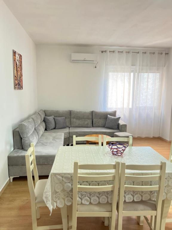 a living room with a table and a couch at Cameria in Durrës