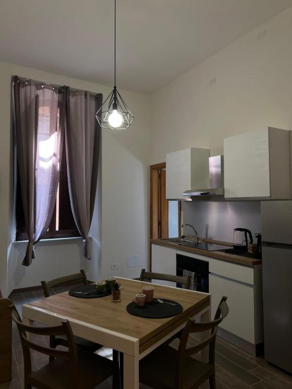 a small kitchen with a wooden table and a dining room at Trasimeno Vacanze in Passignano sul Trasimeno