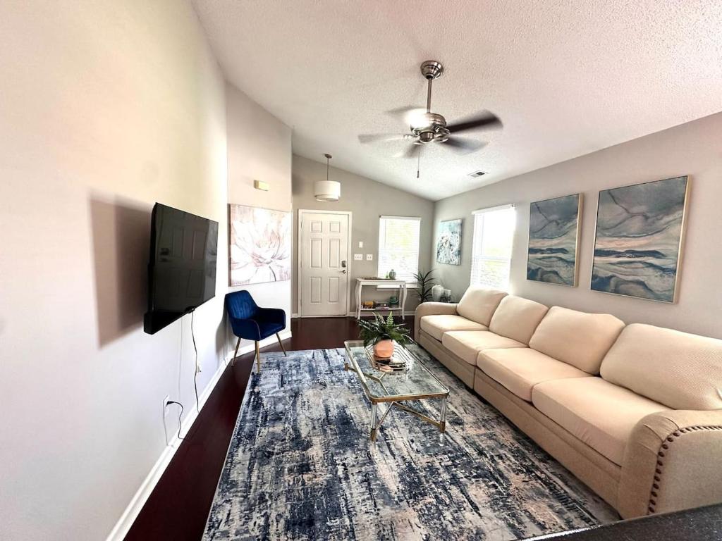 a living room with a couch and a tv at Modern comfort 2BR-2BA Retreat in Concord
